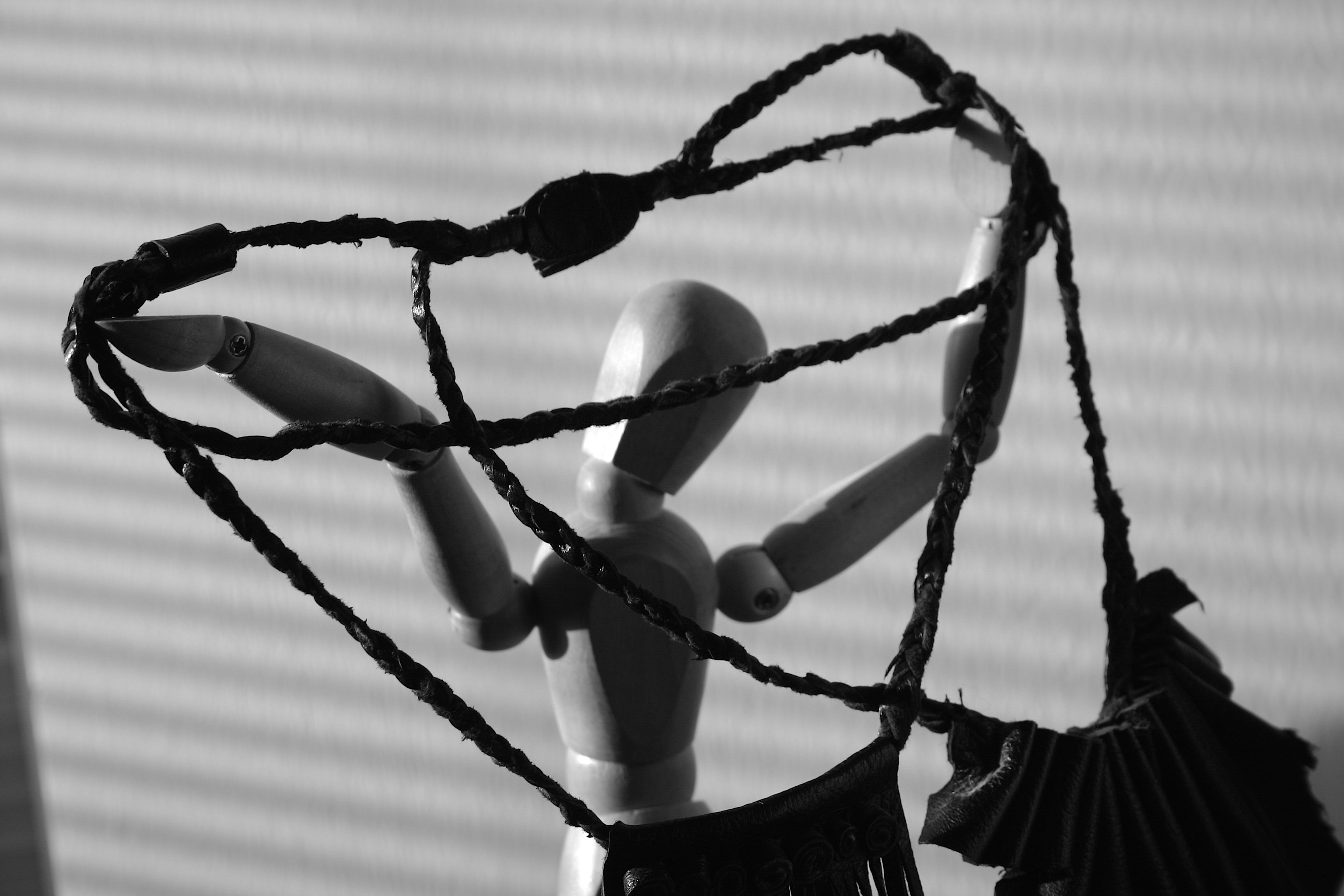 doll with leather cord