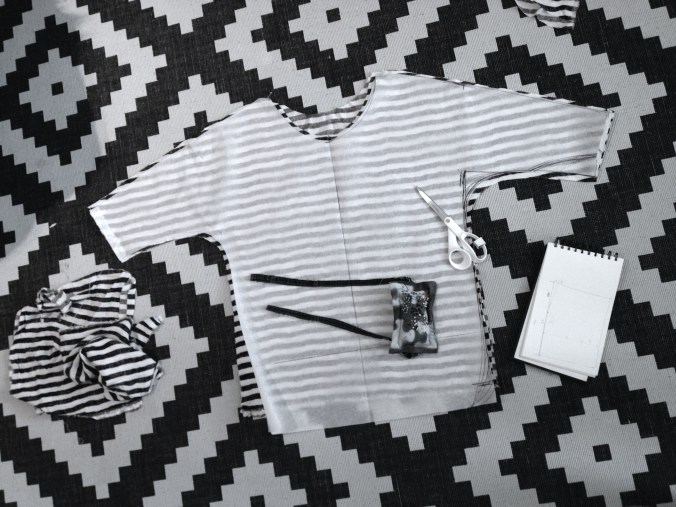 cutting out the batwing sleeve shirt from striped fabric