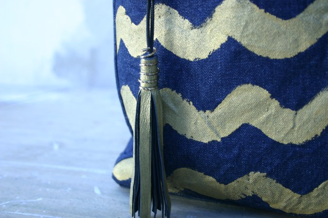 diy denim bag with painted gold colored waves and matching tassel